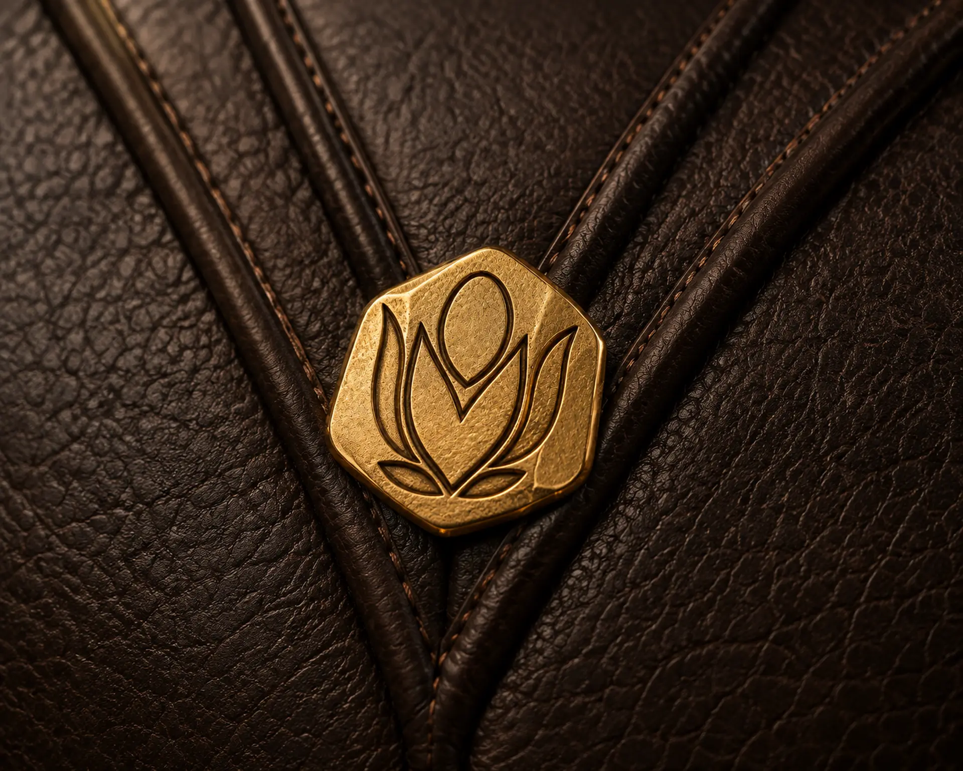 Macro view of the 30 mm 24-karat gold-plated MBALI Nugget recessed into the Khaya's sculpted protea lines
