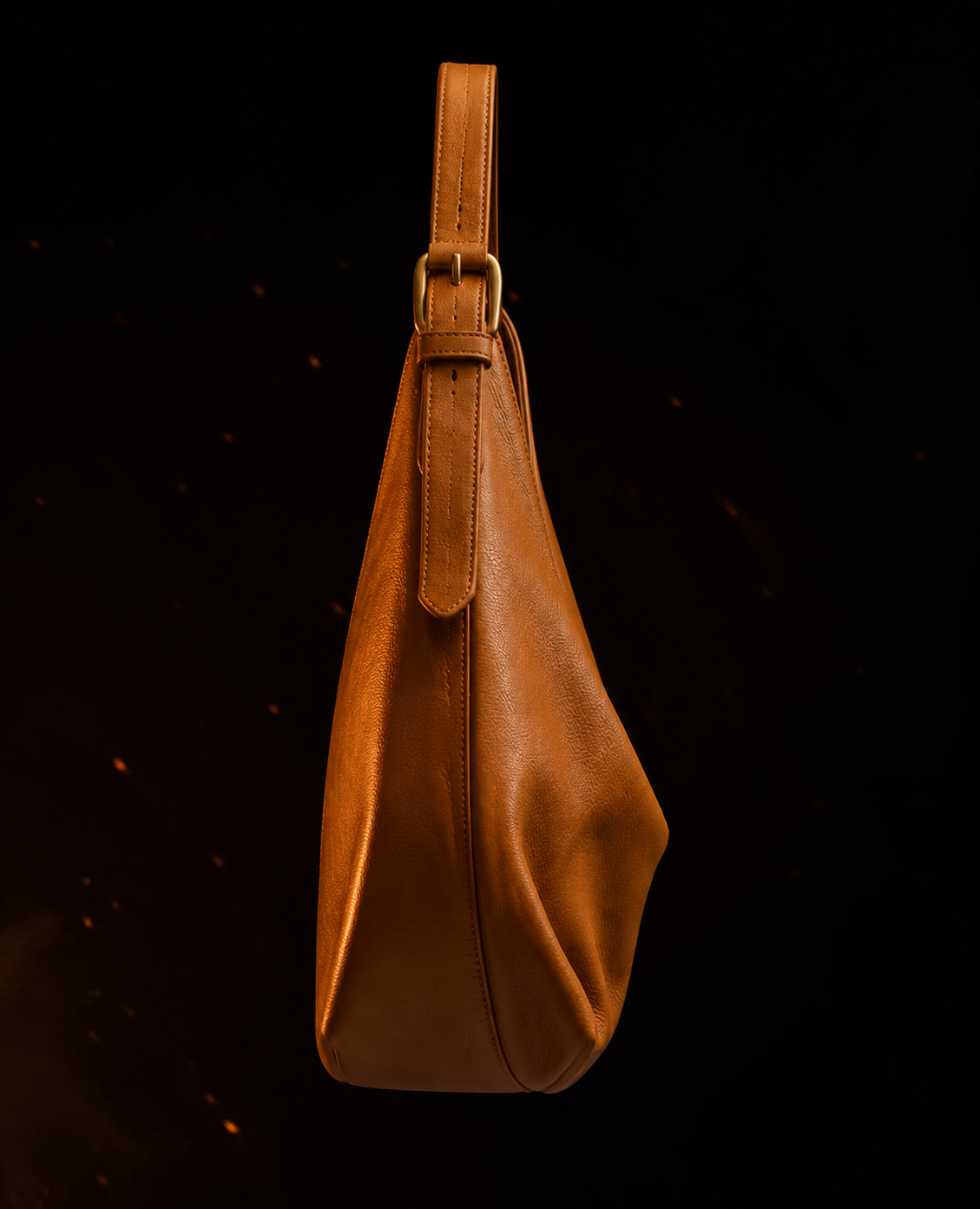 The Bonolo in profile, showing the gusseted depth and gold-plated strap buckle