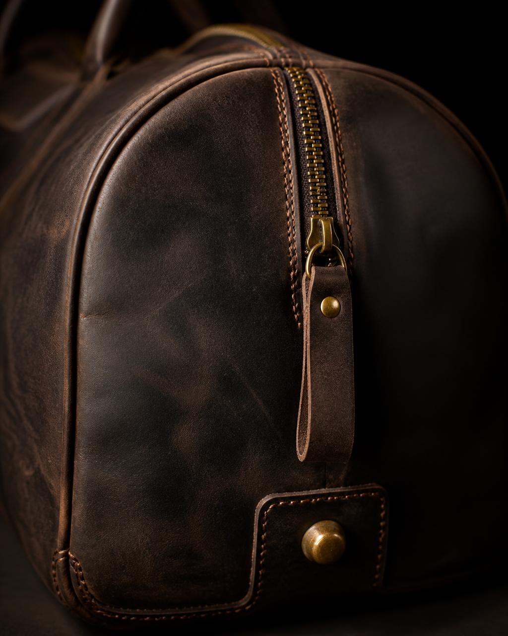 Khaya end panel detail — gold zip pull and base stud