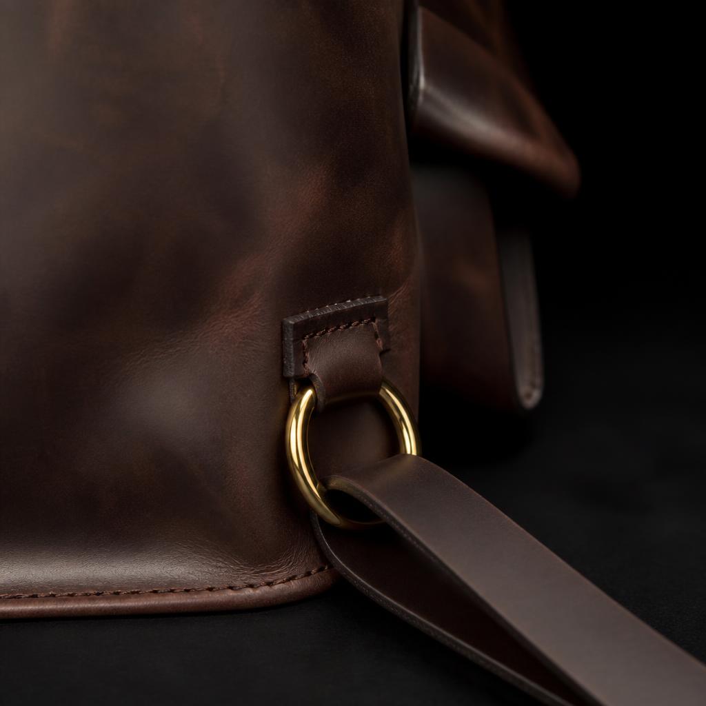 Sizwe strap anchor detail — heavy gold ring and buckle